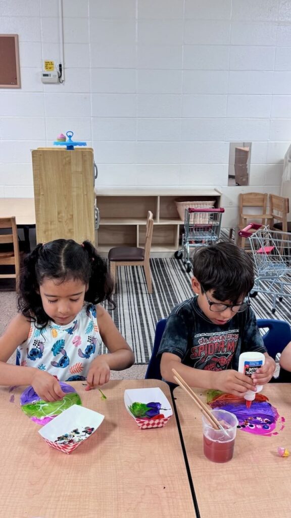 Two preschoolers making crafts together in downtown Napa