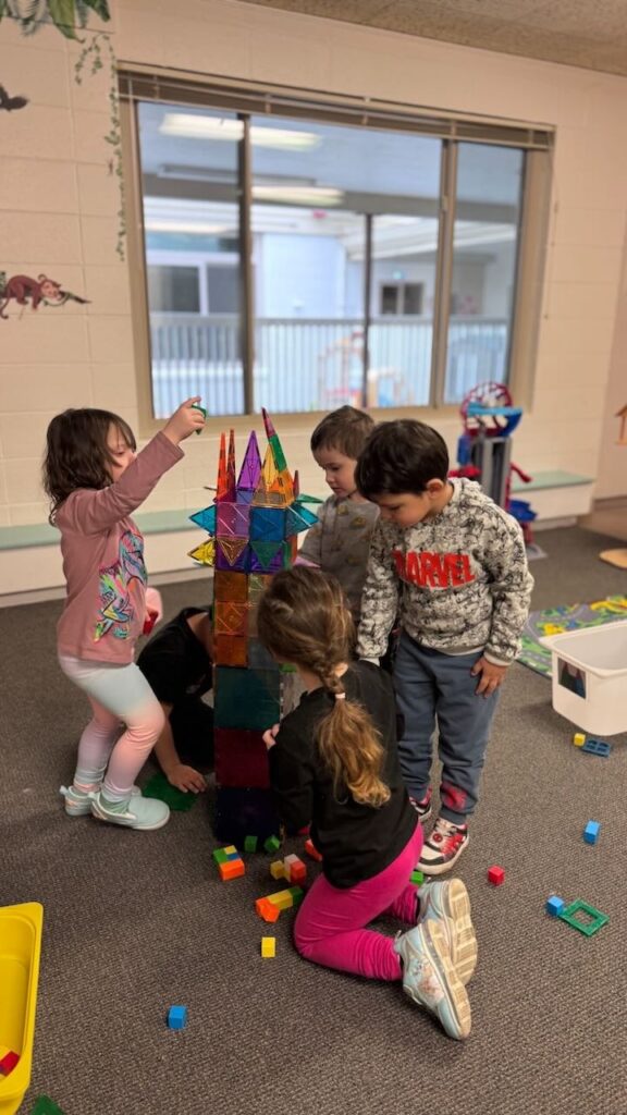 children make a tower out of magnet tiles in their preschool classroom in napa