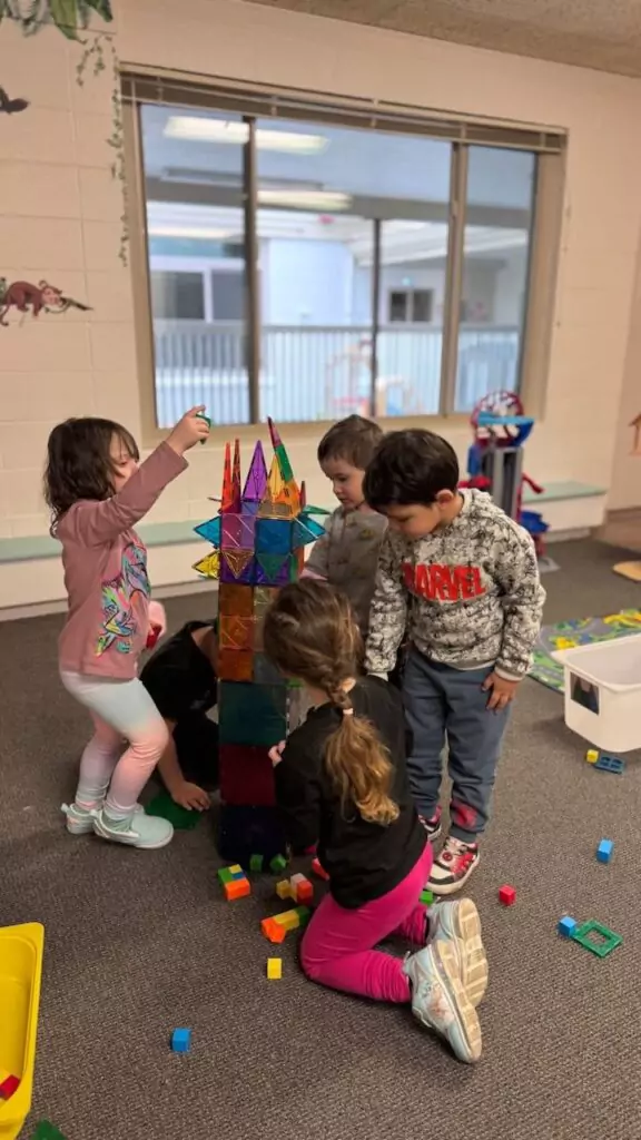 children make a tower out of magnet tiles in their preschool classroom in napa