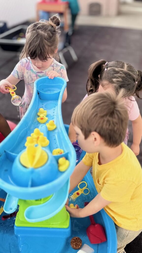 children play at a water table at preschool in napa ca